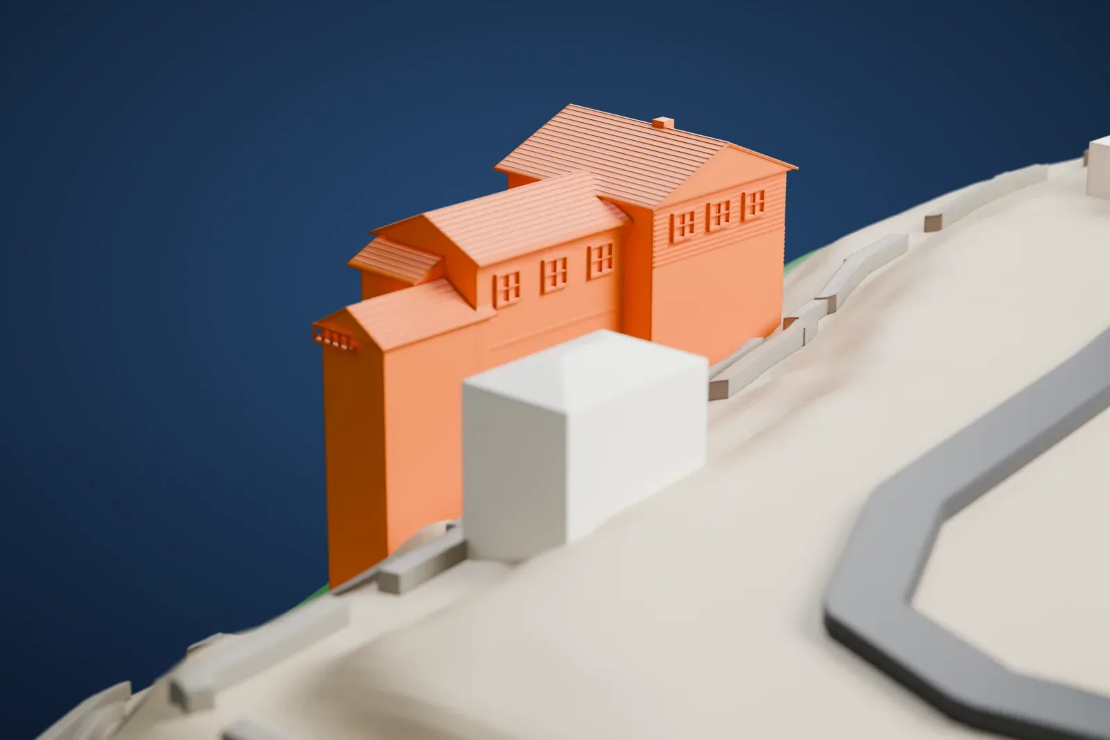 A white 3D print of the Kolb Studio with stepped roofs and small balcony rails on steep terrain beside nearby buildings and roads.