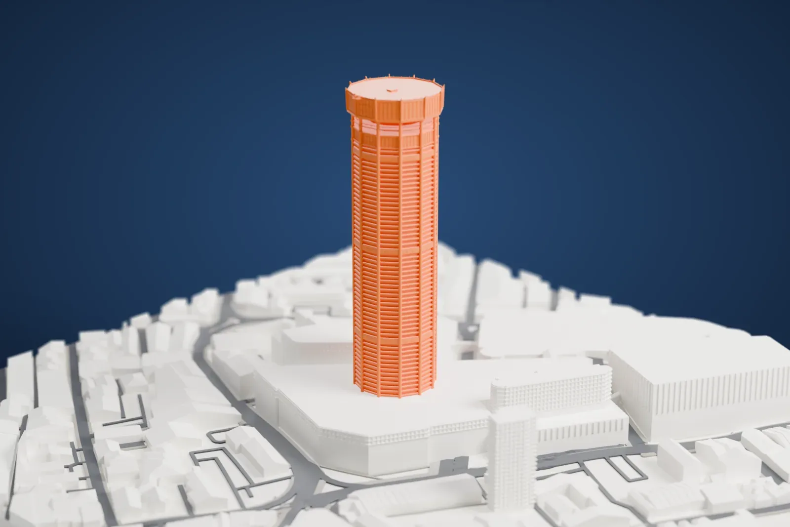 A white 3D print of Komtar, a tall twelve-sided tower with a projecting crown, rising above the streets and buildings of George Town.