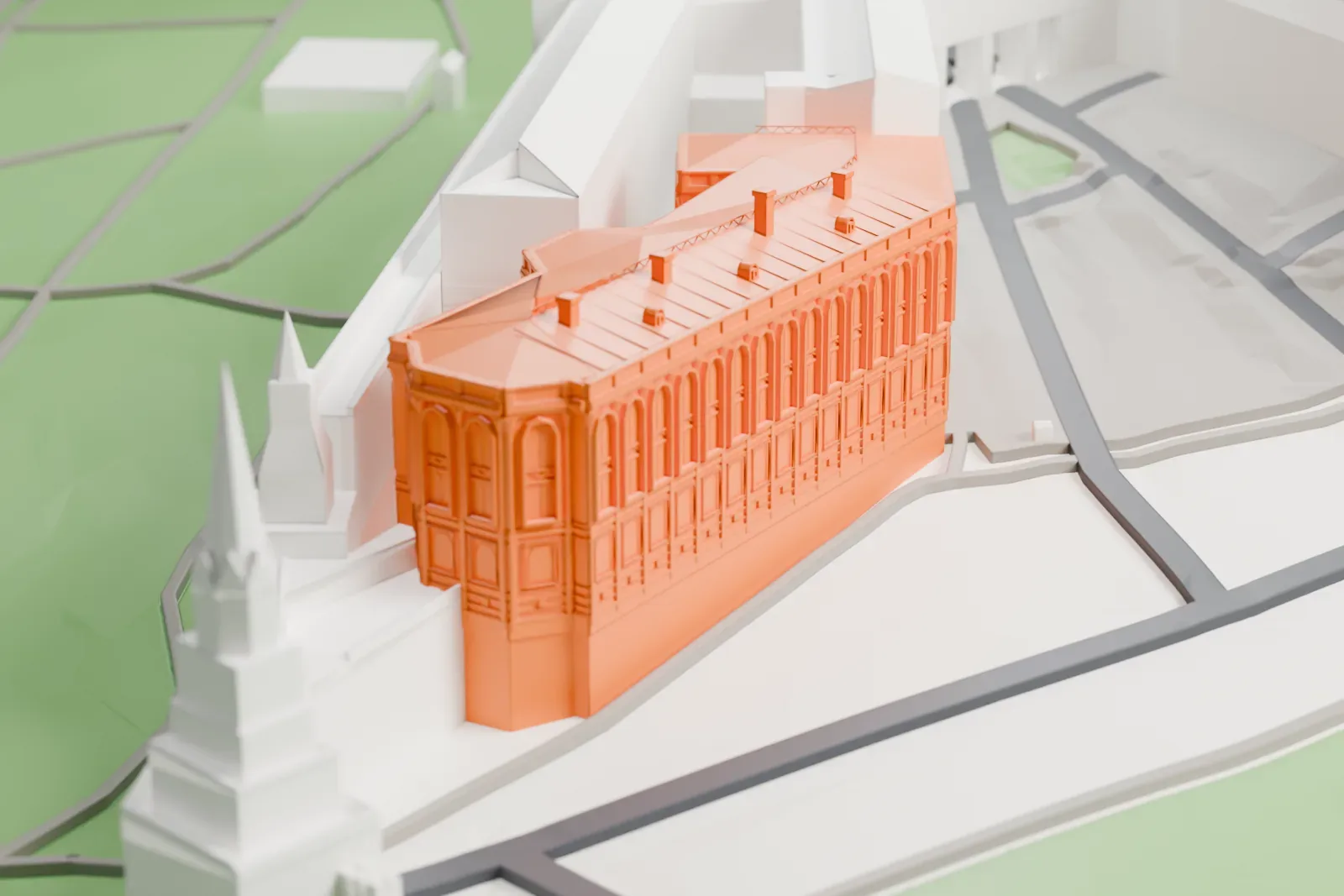 A white 3D print of the Kremlin Armoury, a museum building inside the Moscow Kremlin, among the surrounding buildings of the Kremlin.