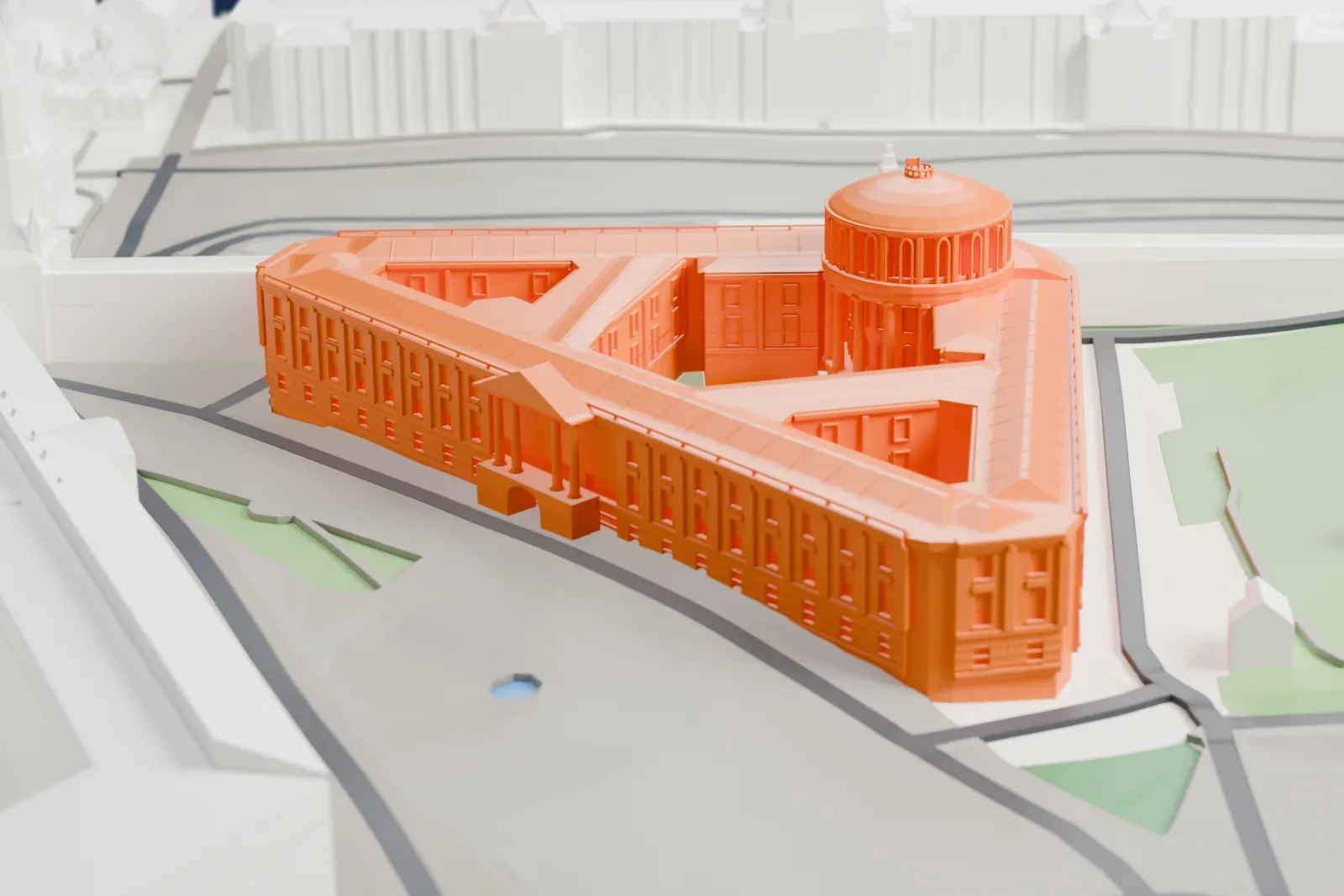 A white 3D print of the Kremlin Senate, a broad building mass on its footprint, with the Kremlin Wall and other buildings of the Moscow Kremlin around it.