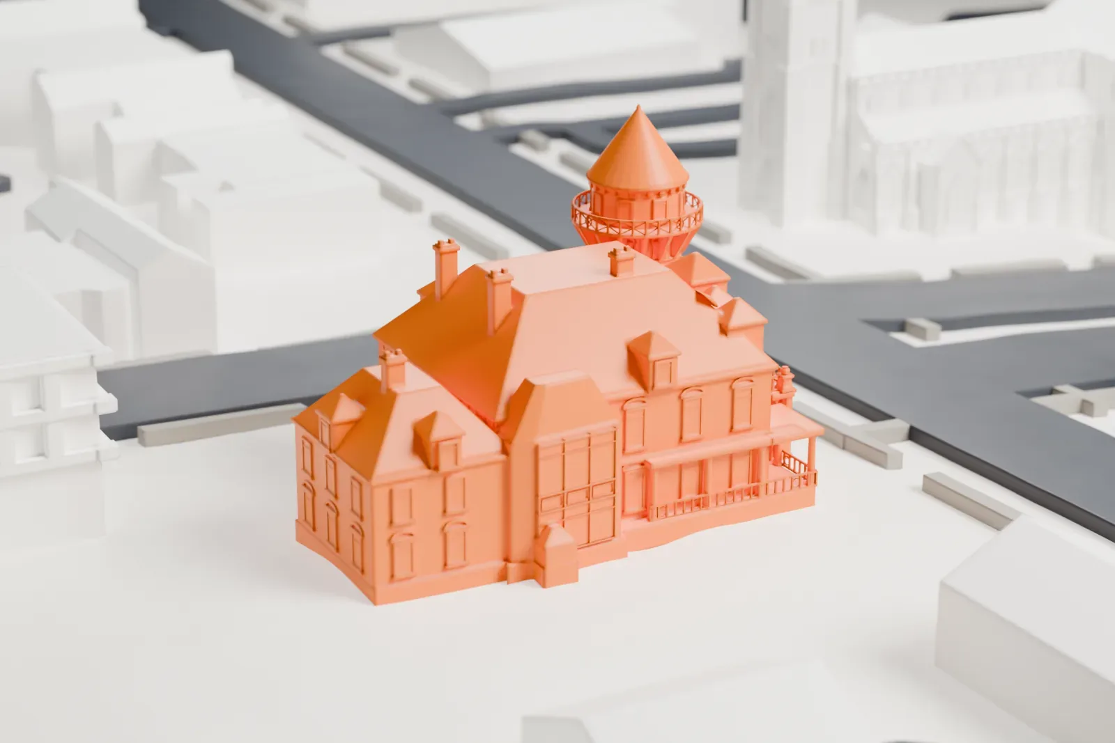 A white 3D print of the Krueger Mansion, a large house with a tall round tower under a cone roof, dormers, chimneys and a front porch, on a corner lot between streets.