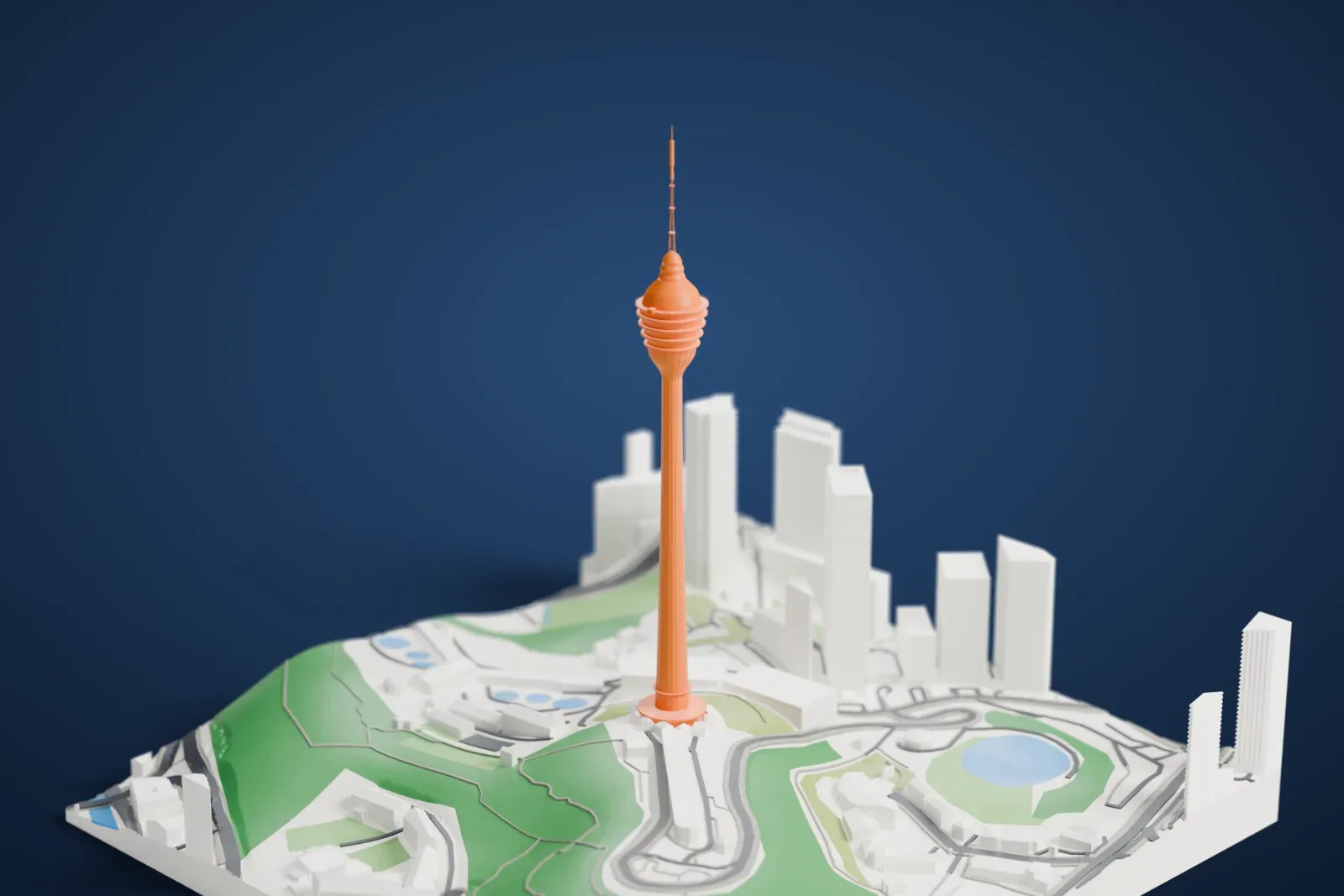 A white 3D print of the Kuala Lumpur Tower, with its long tapered shaft, broad stacked head and tall antenna, rising above surrounding city buildings.