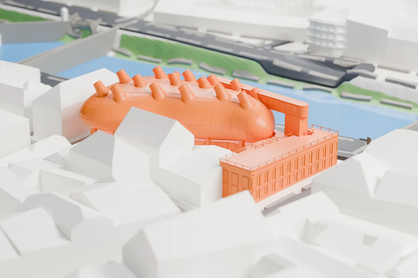 A white 3D print of the Kunsthaus Graz with a rounded roof and angled tubes, surrounded by buildings and streets beside a river and bridge.