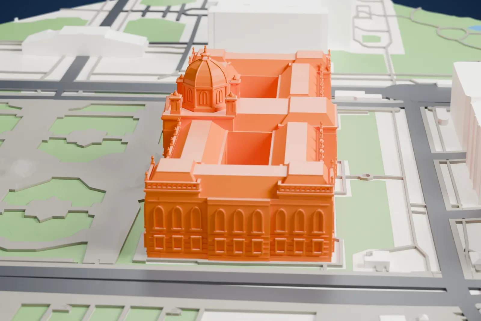 A white 3D print of the Kunsthistorisches Museum, a wide rectangular museum block, with the surrounding streets and buildings of Vienna around it.