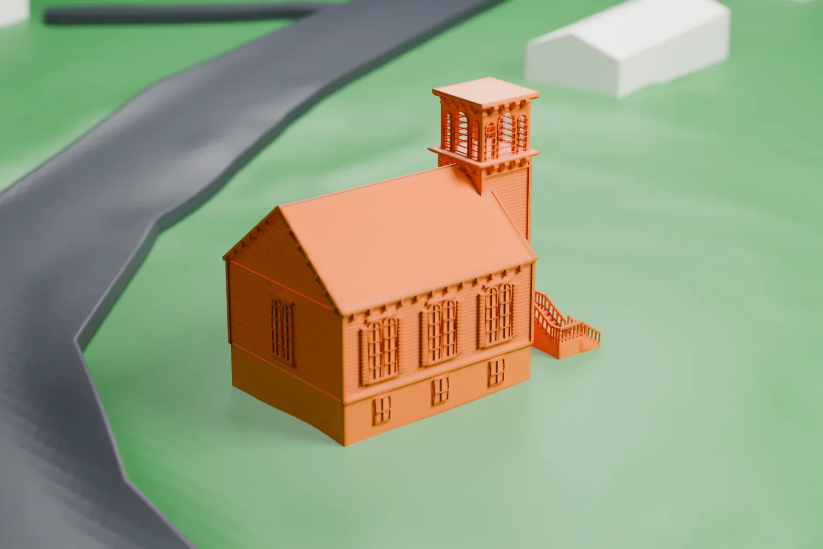 A white 3D print of the Ladentown United Methodist Church, a gabled church with a tall tower, standing alone on green ground beside a road.