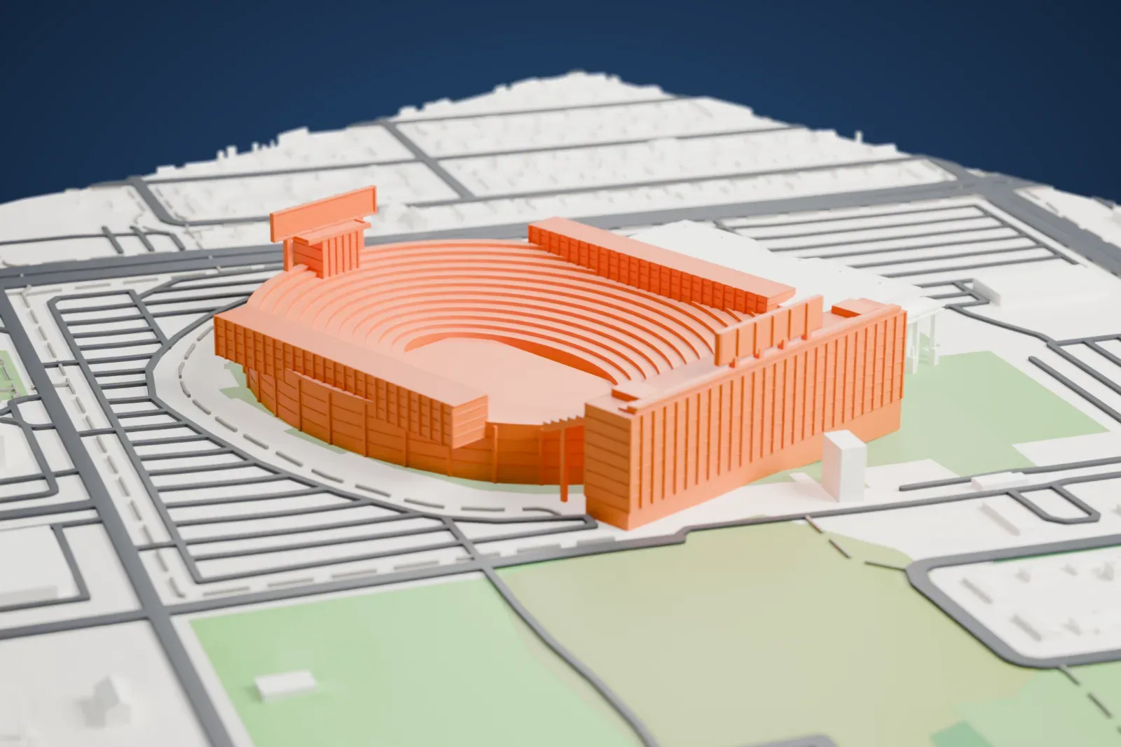A white 3D print of Lambeau Field, an oval bowl of many stepped seating tiers with a tall block along one side, surrounded by parking lots, streets and open fields.