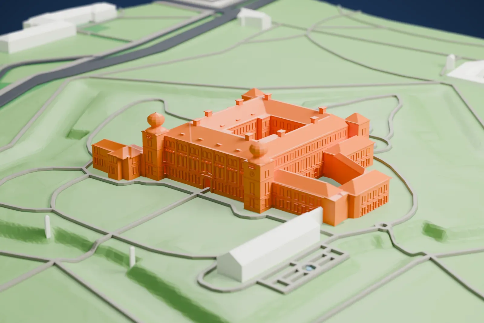 A white 3D print of Łańcut Castle among the surrounding streets and buildings.