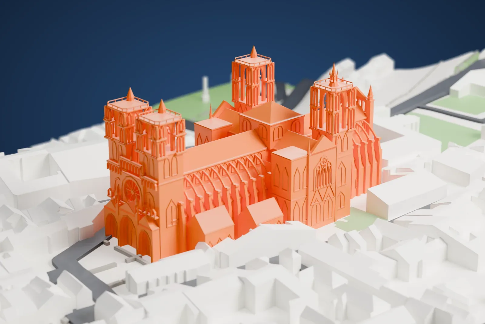 A white 3D print of the Laon Cathedral model with its towers and buttresses, surrounded by buildings, streets, and patches of green space.