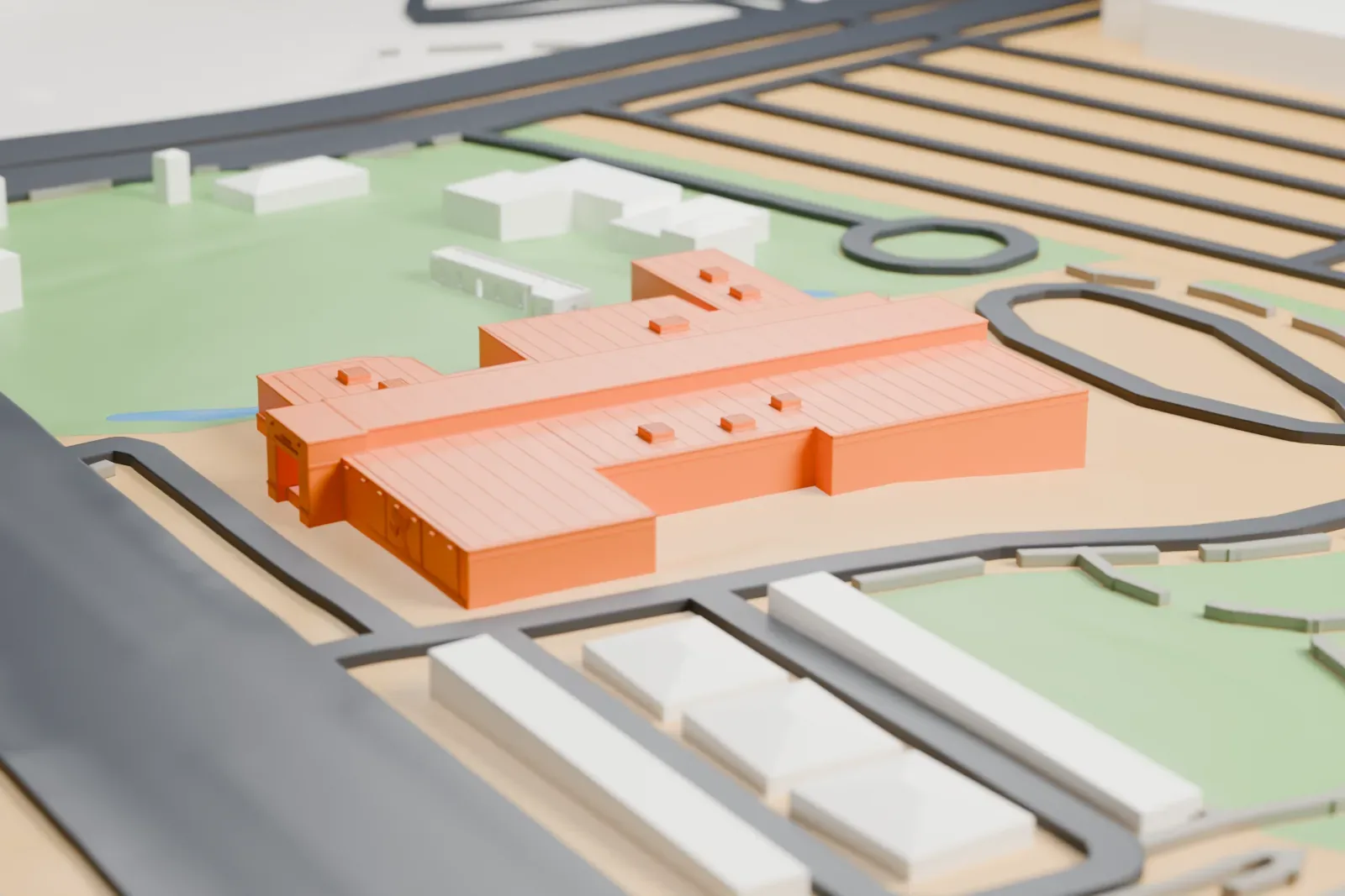 A white 3D print of the Las Vegas Natural History Museum, a low, stepped building with a flat roof and small rooftop units, beside a park with a small waterway and looping roads.