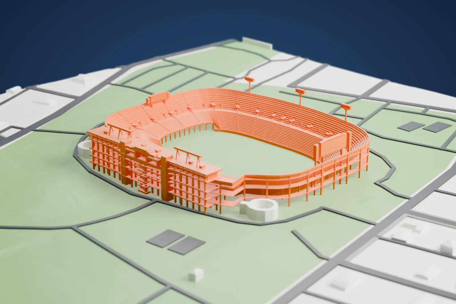 A white 3D print of Legion Field, an open football bowl with a tall west press box, exposed seating frames and scoreboards on legs, among surrounding streets and buildings.