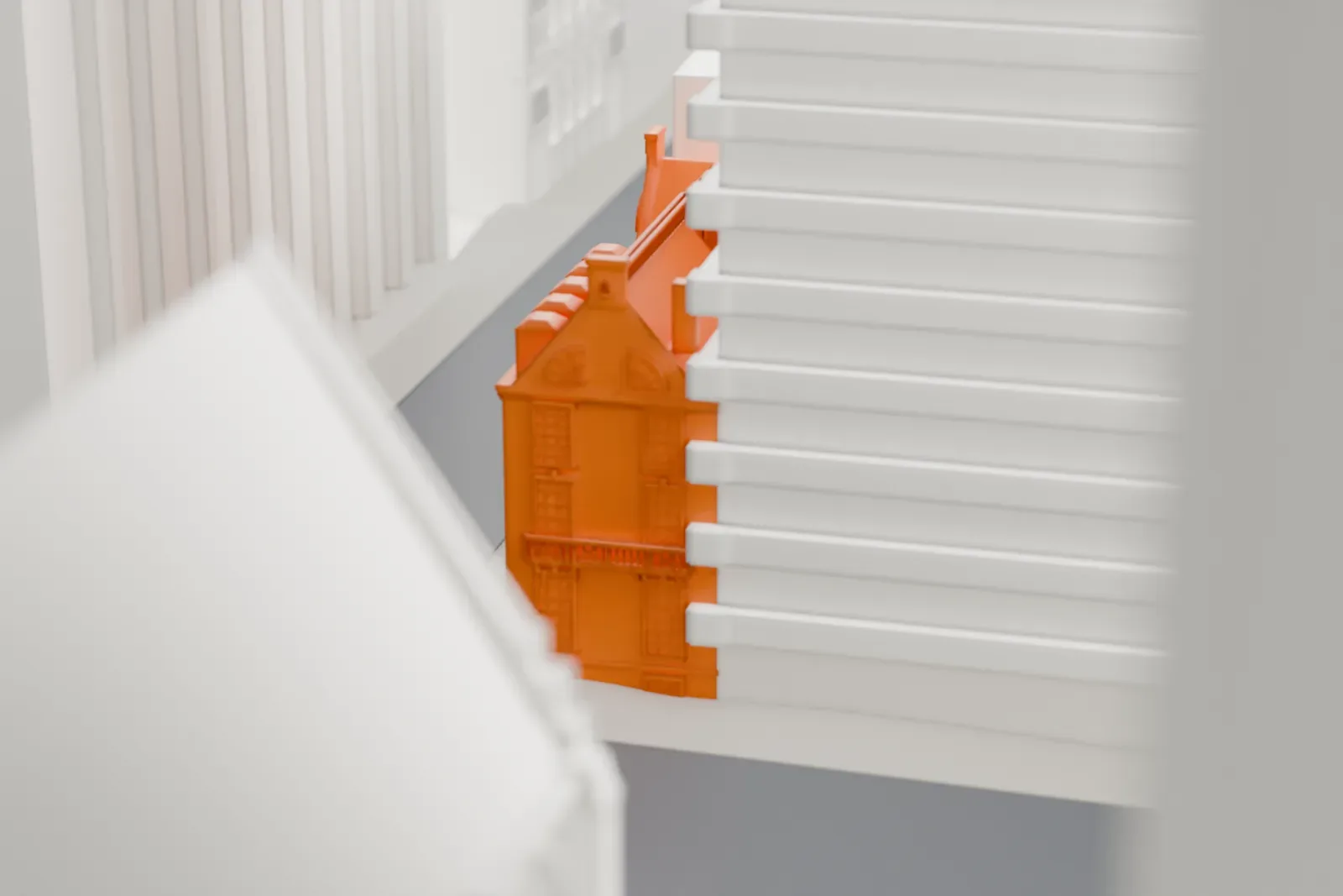 A white 3D print of the Lewis G. Morris House, a house with dormer windows, a balustrade and a small cupola, almost hidden between much taller buildings.