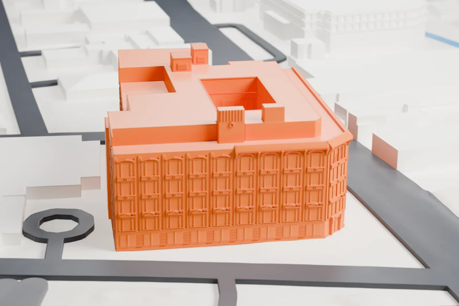 A white 3D print of the Life Savers Building, a large block with rows of windows, small rooftop boxes and a notch cut into its roof, on a street corner.
