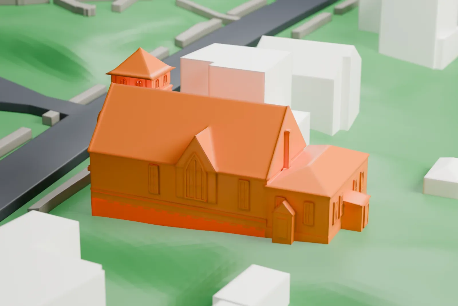 A white 3D print of a gabled church with a square corner tower, surrounded by houses and green lawns.