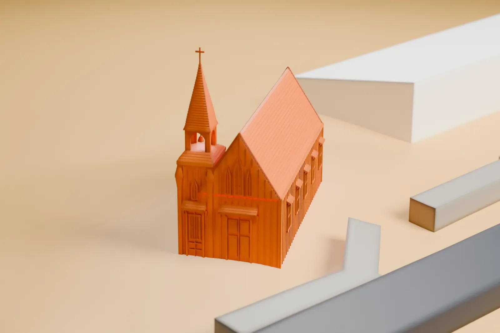 A white 3D print of the Little Church of the West, a small gabled chapel with a steeple, beside roads on open sandy-colored ground.