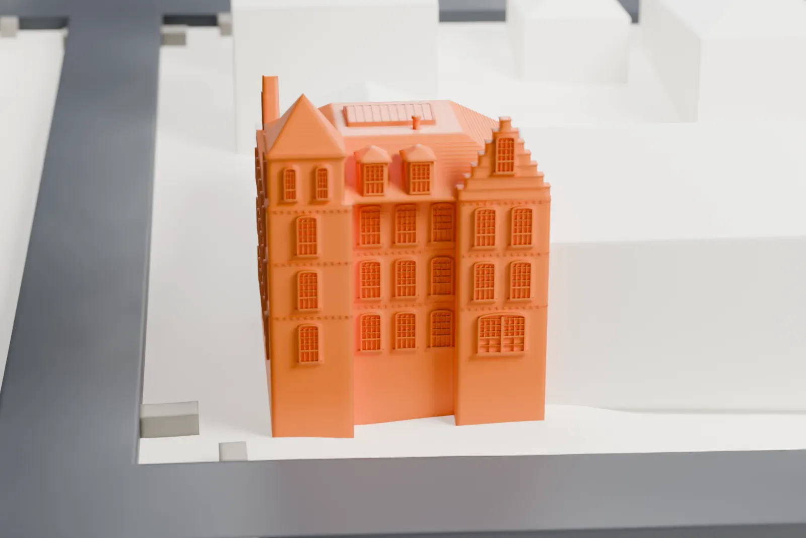 A white 3D print of the Lord & Burnham Building, a tall corner building with a pyramid-roofed tower and a mansard roof, beside two streets.