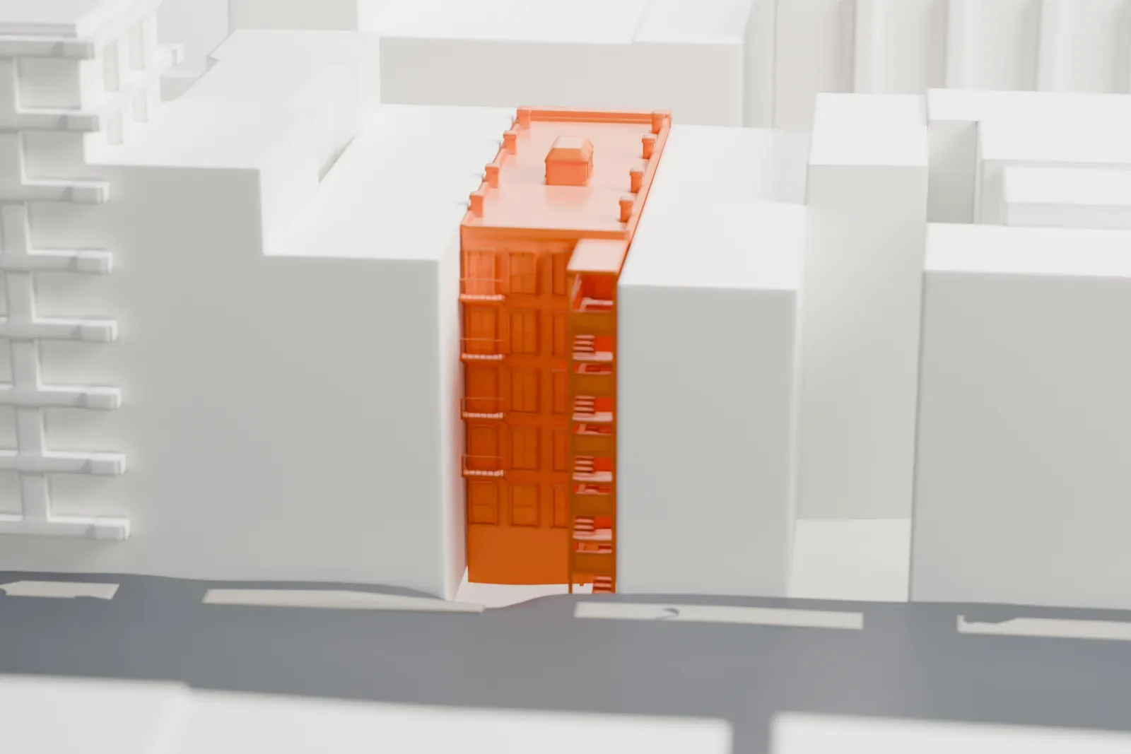 A white 3D print of the Lower East Side Tenement Museum, a narrow building with balconies between taller neighboring buildings.