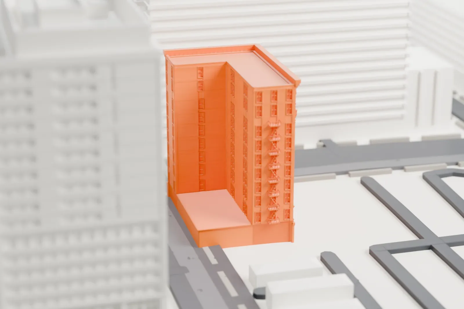 A white 3D print of the Luhrs Building, a tall block with a row of arched windows and a heavy cornice at the top, between wide downtown streets and larger blocks.