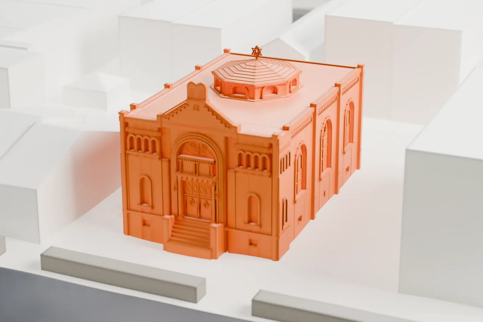 A white 3D print of Magen David Synagogue, a two-story brick synagogue with arched windows and a small octagonal lantern on its roof, among low buildings on a city block.