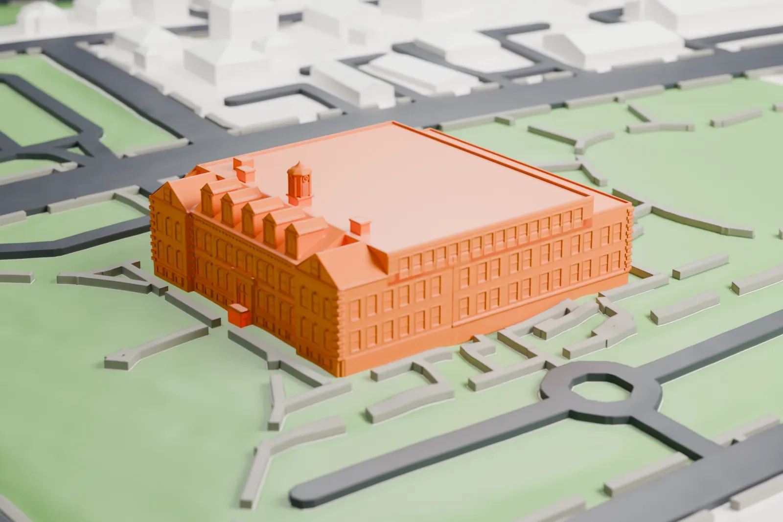 A white 3D print of the Main Street School, a large school building with a rooftop cupola and a row of dormers, set among lawns, paths and streets.