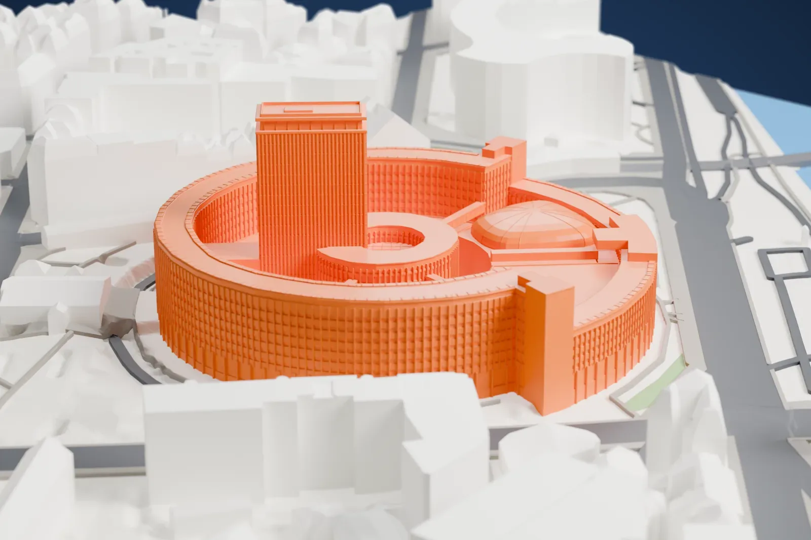 A white 3D print of the Maison de la Radio, a ring-shaped building around a central tower, among surrounding streets and buildings.