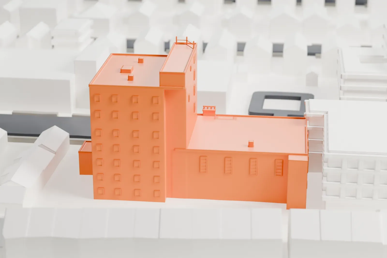 A white 3D print of the Manhattan Beach Jewish Center, a tall rectangular block joined to a lower wing, among low neighboring buildings and streets.