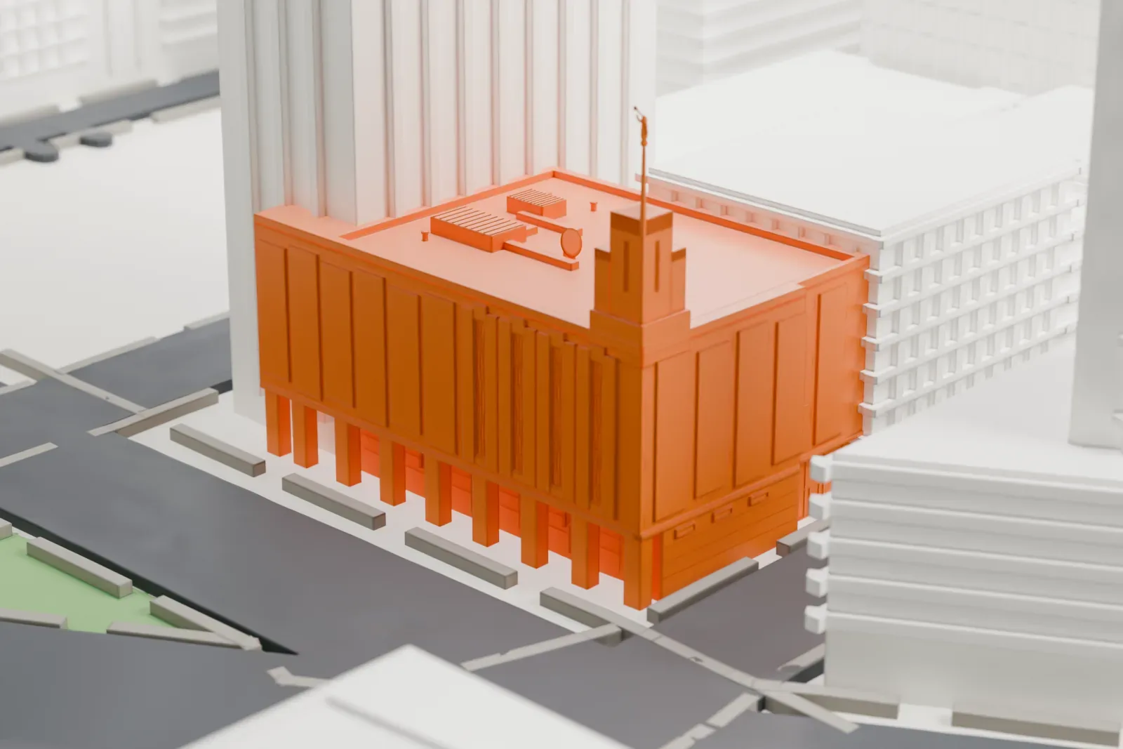 A white 3D print of the Manhattan New York Temple, a flat-roofed building with a small rooftop tower and a thin mast, hemmed in by high-rise towers.