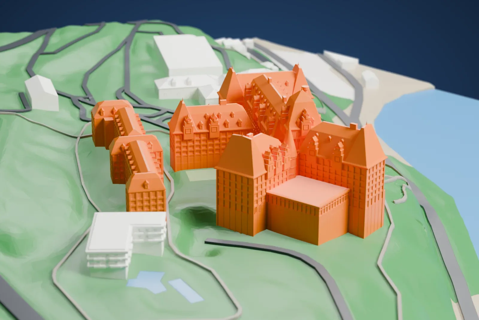 A white 3D print of Manoir Richelieu among the surrounding streets and buildings of La Malbaie.