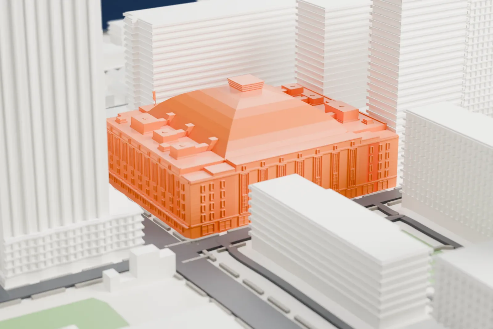 A white 3D print of Maple Leaf Gardens, a boxy arena with a shallow curved roof and small blocks at the roof corners, hemmed in by tall towers on city streets.