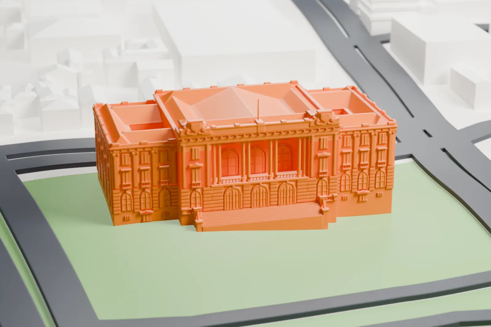 A white 3D print of Maputo City Hall, a wide building with hipped roofs and a front staircase, set on a green lawn among curving roads and low buildings.