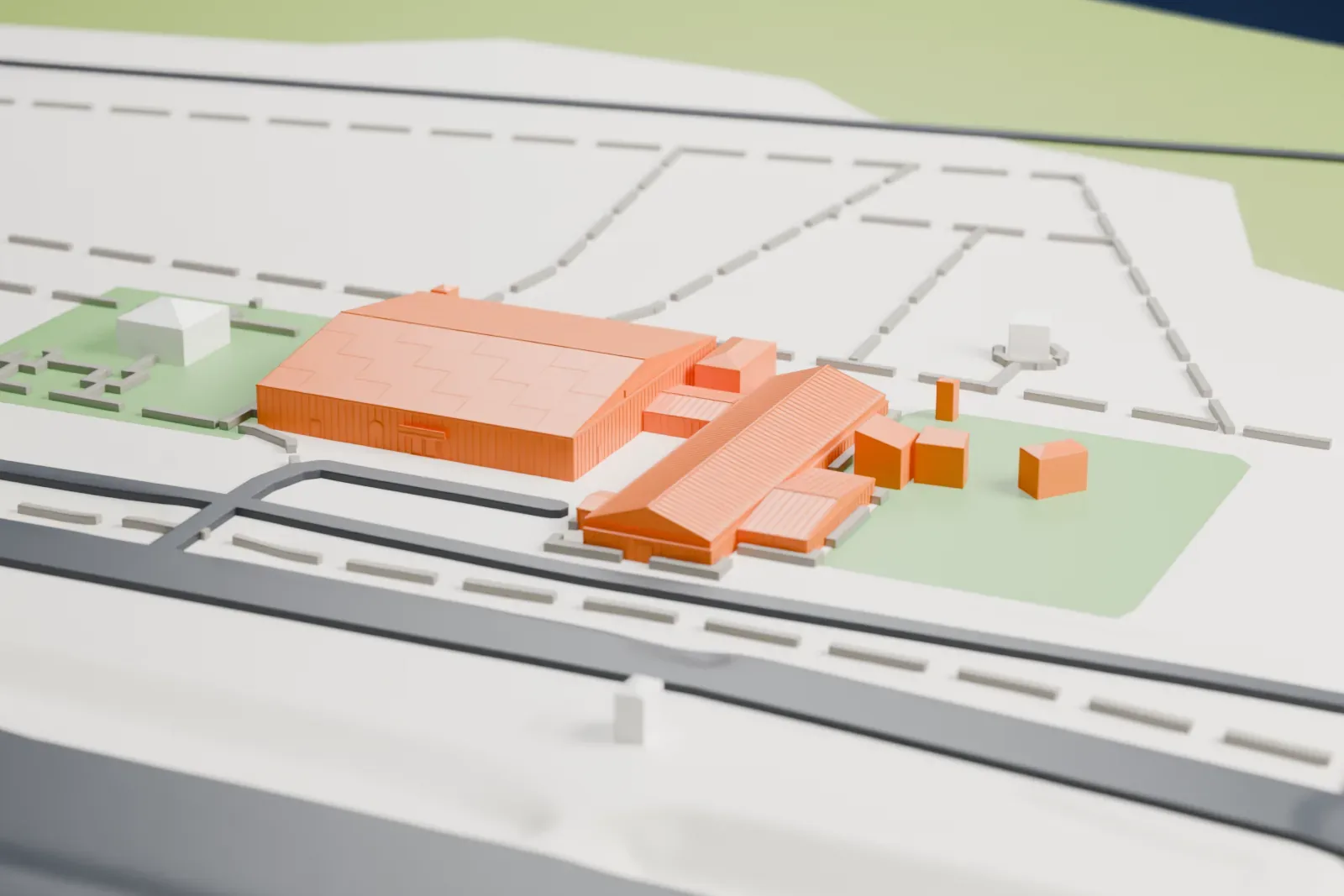 A white 3D print of the March Field Air Museum hangars, a wide low-roofed hangar beside a long gabled hall, on open ground with a few small buildings, lawns and roads around them.