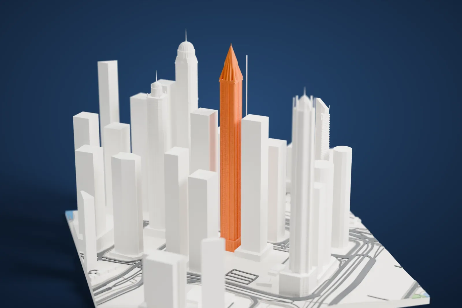 A white 3D print of Marina 101 rising above the surrounding streets and buildings of Dubai Marina.
