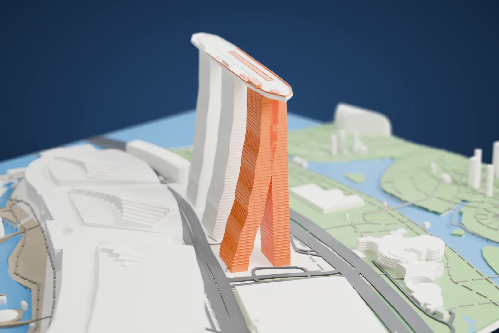 A white 3D print of Marina Bay Sands, three tall leaning hotel towers joined at the top by a long, ship-shaped platform, beside the waterfront, a curved mall building and the gardens of Marina Bay.