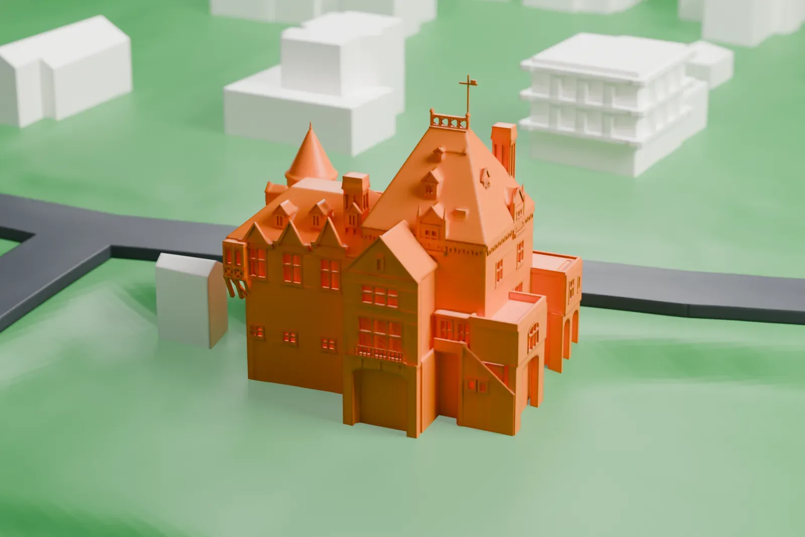 A white 3D print of the Marion Castle, a chateau-style house with round turrets, steep roofs and a cross finial, standing on a green lawn beside curving roads.