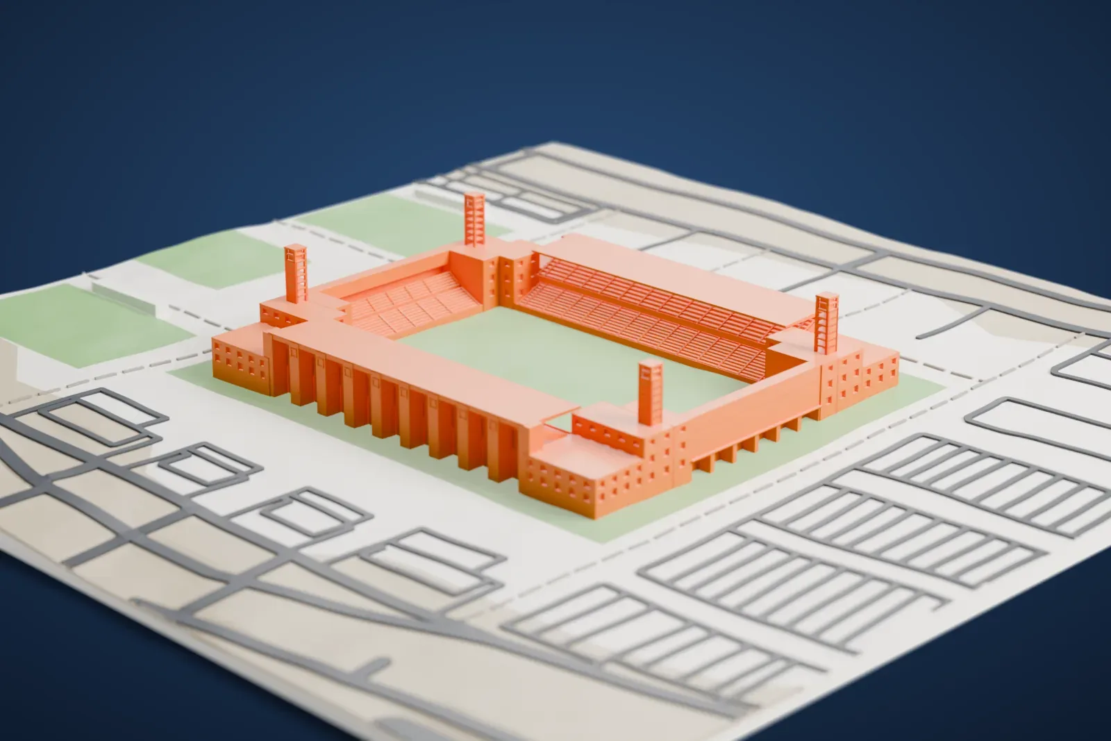 A white 3D print of the Marrakesh Stadium, a rectangular bowl with tall pylons along its sides and four open-frame floodlight towers at the corners, among the streets and buildings around it.