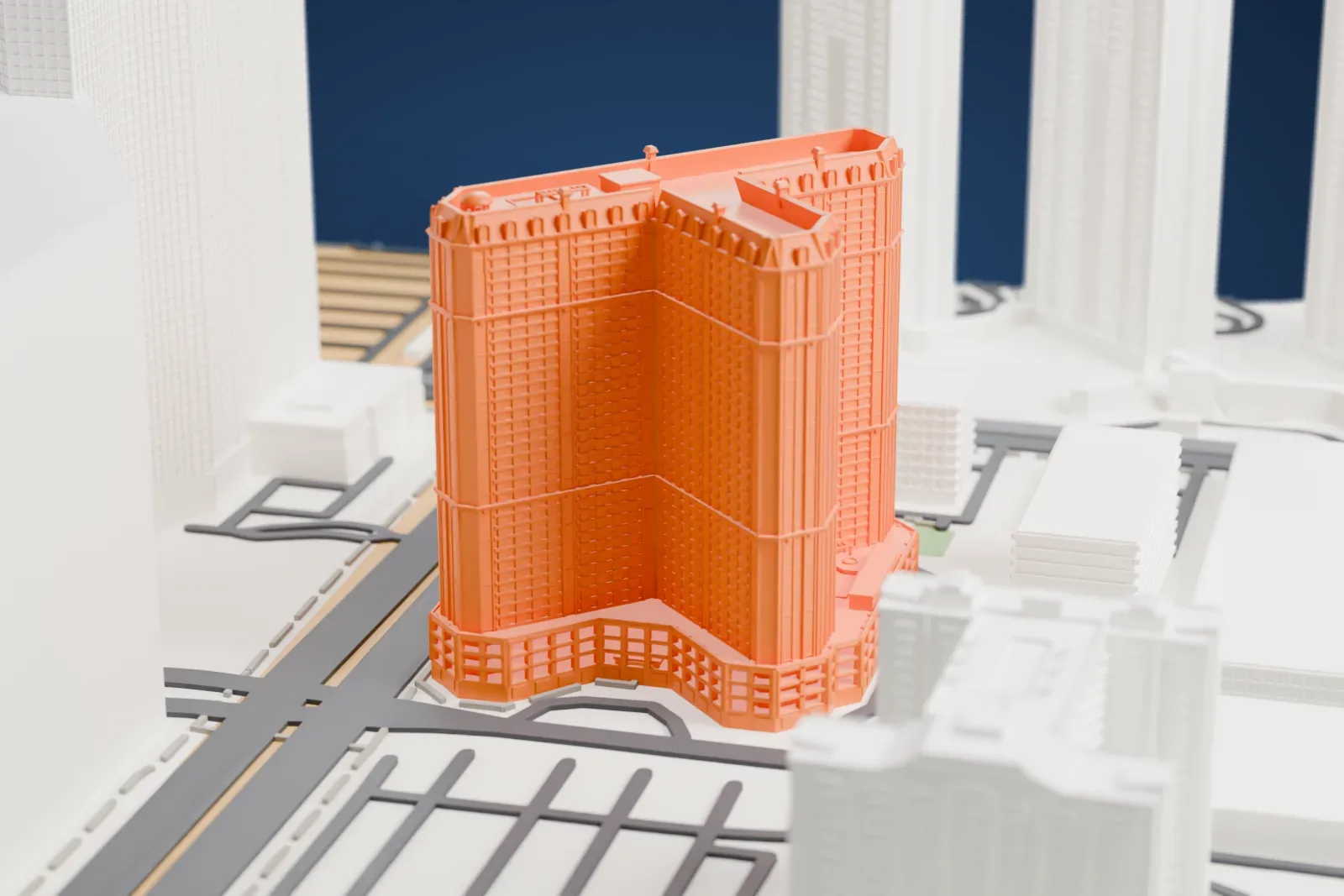 A white 3D print of Marriott's Grand Chateau, a tall tower with a decorated crown and a wide low base, standing beside a large neighboring building and busy roads.
