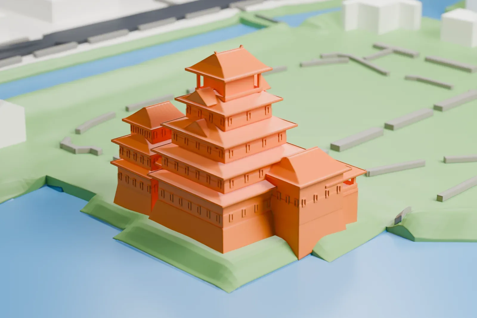 A white 3D print of Matsumoto Castle, a stacked keep with layered overhanging roofs and a smaller tower beside it, standing on green ground surrounded by water.