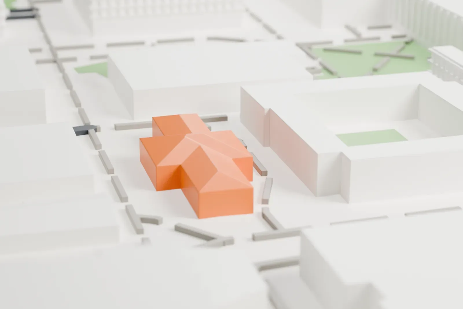A white 3D print of Matthews Hall, a low two-story building with side wings, with campus paths and larger neighboring buildings around it.