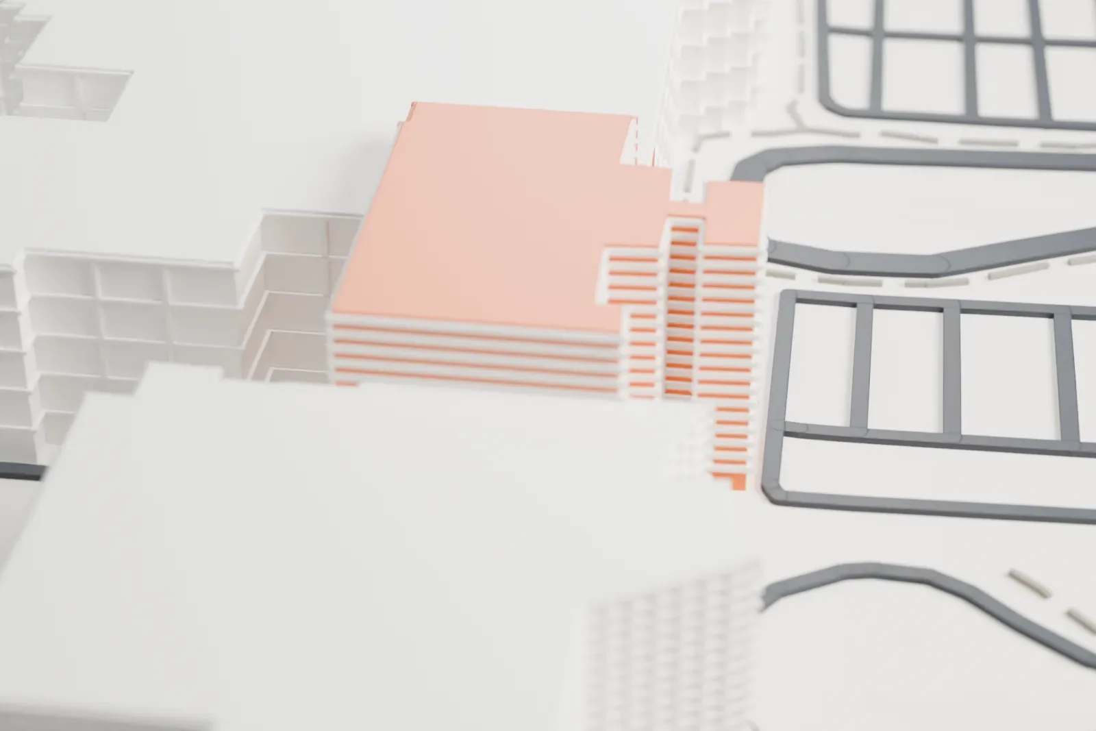A white 3D print of the Mayo Clinic Hospital campus, a cluster of joined low and mid-rise wings among parking lots, roads and a few larger buildings.