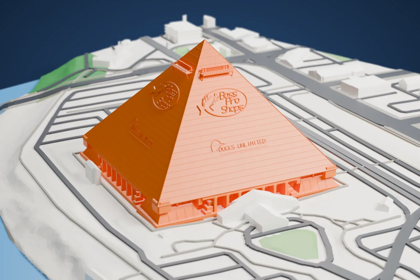 A white 3D print of the Memphis Pyramid, a pointed pyramid beside the Mississippi River, among surrounding streets and buildings.
