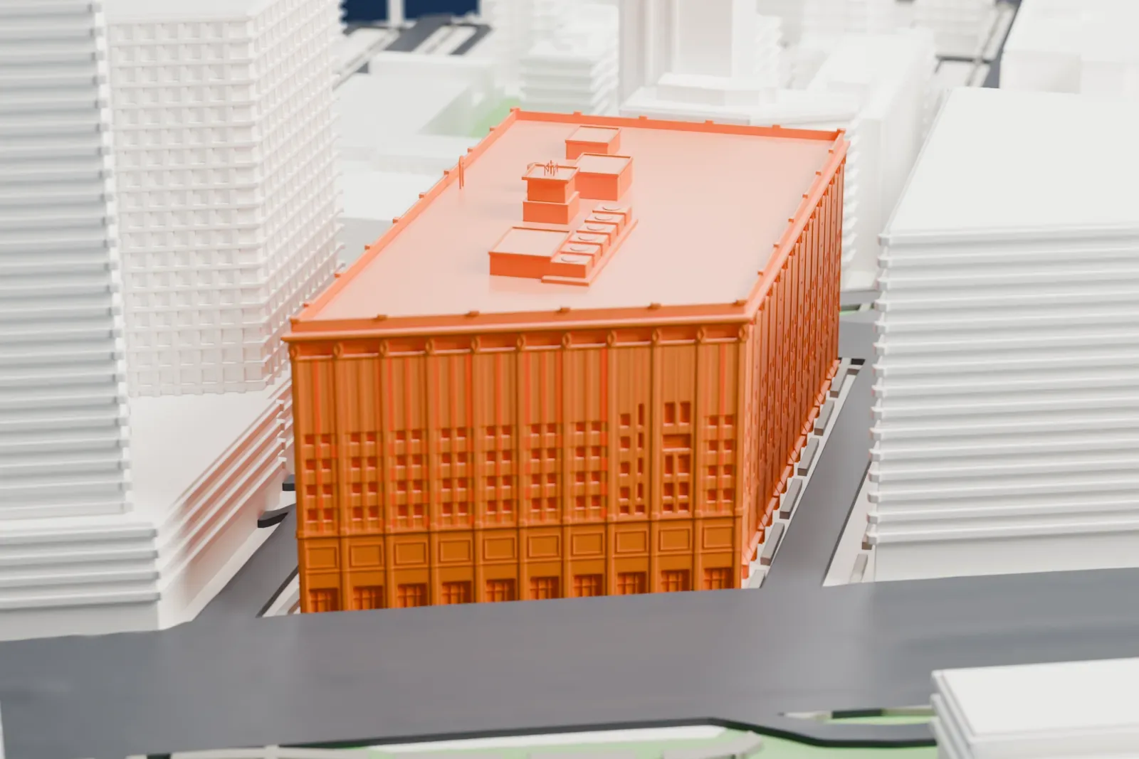 A white 3D print of the Merchants Refrigerating Company Warehouse, a full-block building with a flat roof, among taller towers with open water beyond.