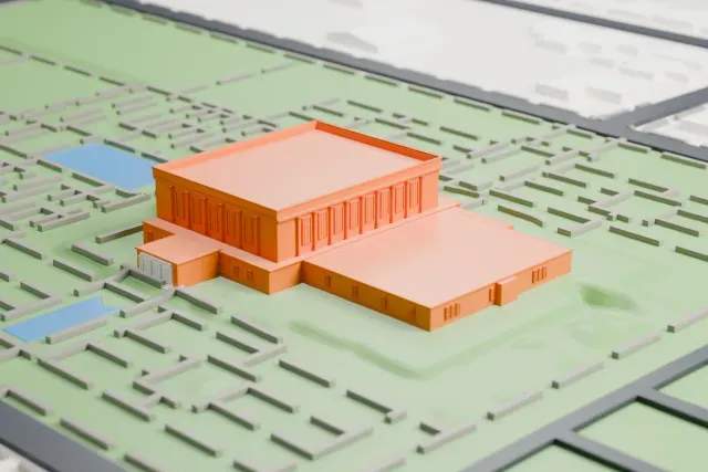A white 3D print of the Mesa Arizona Temple, a long, low, flat-roofed building with attached wings, set in a green garden with thin paths, small pools and streets around it.