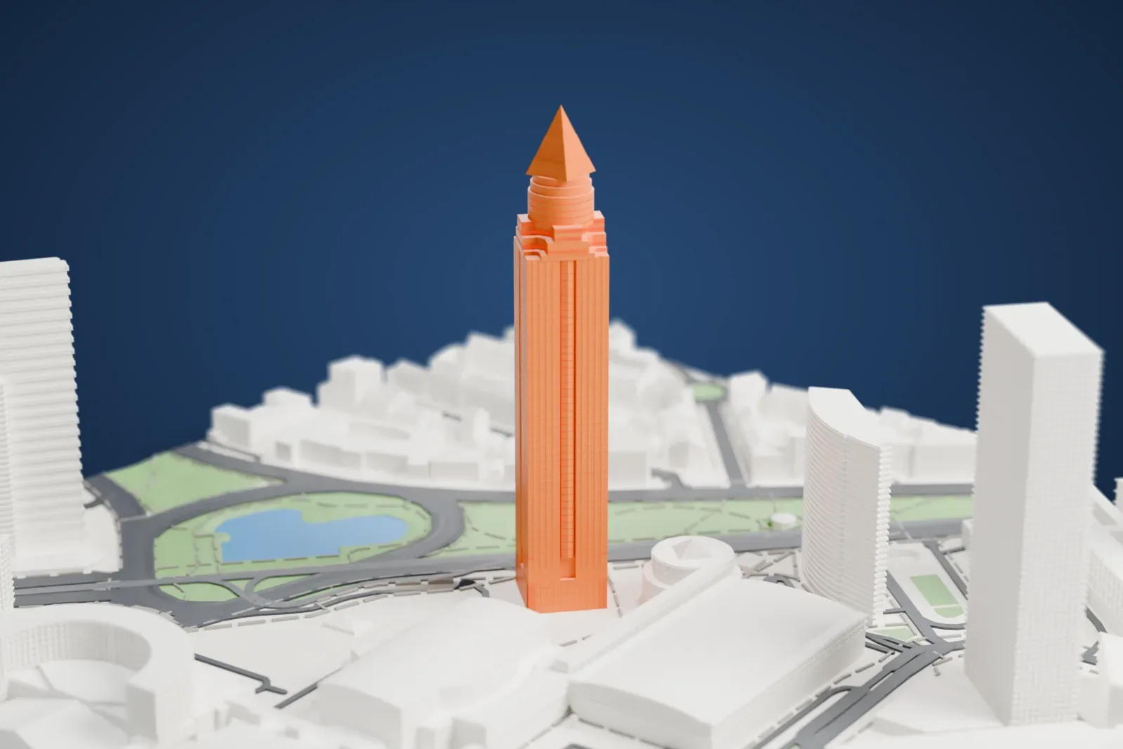 A white 3D print of the Messeturm, a tall square tower topped by a pyramid, rising above fairground buildings, roads and small ponds with green banks.