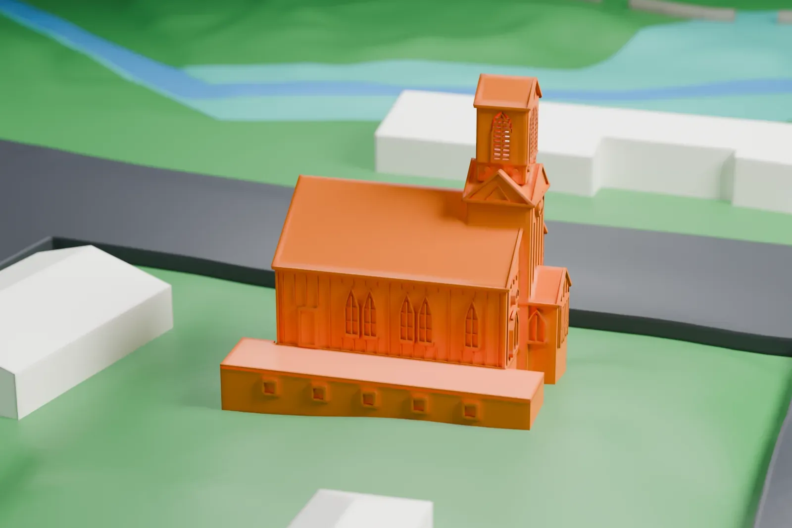 A white 3D print of the Methodist Episcopal Church of Hibernia, a gabled church with a small belfry, on a green lot beside roads and houses.