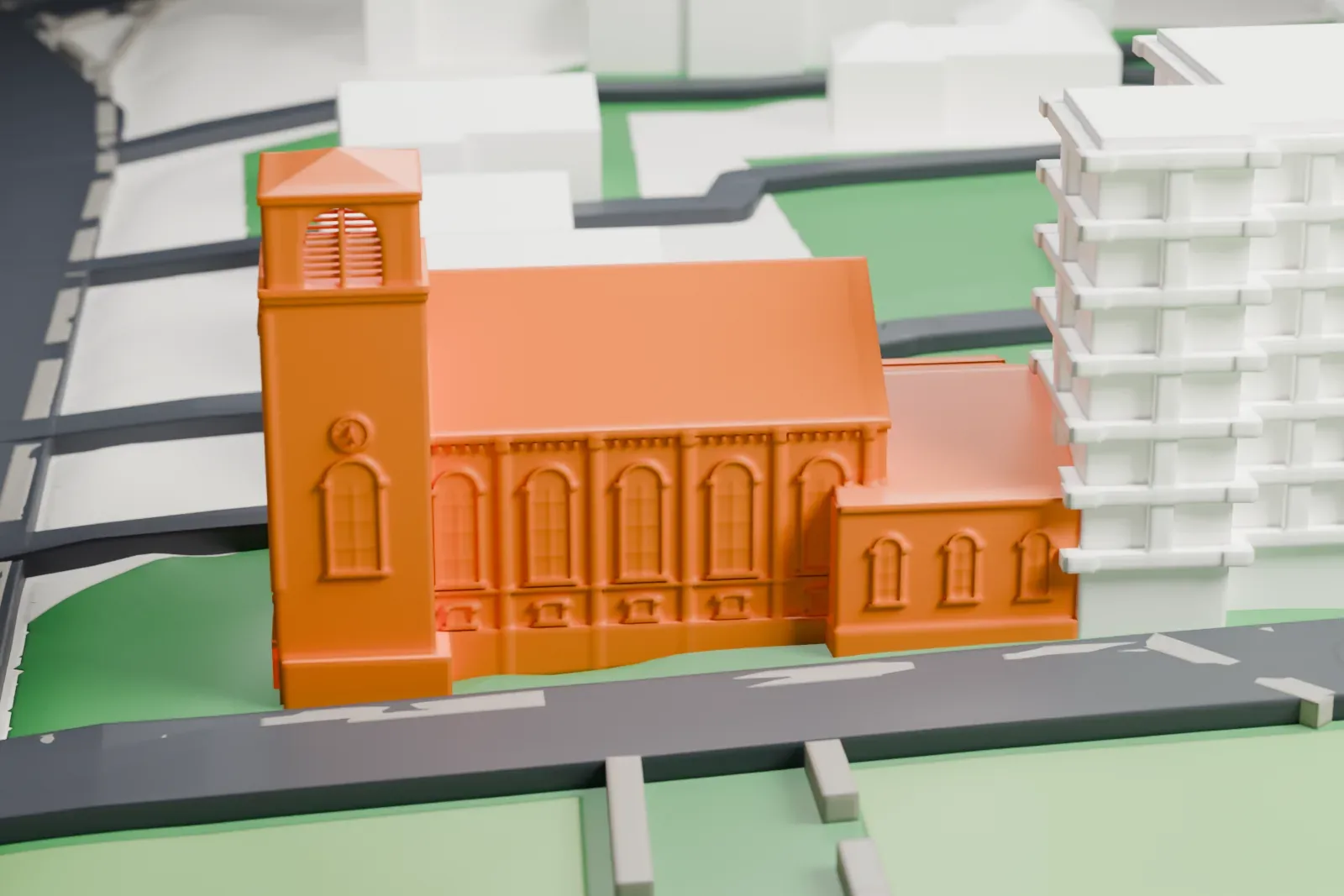 A white 3D print of the Methodist Episcopal Church in Madison, a church with a square bell tower and tall arched windows, beside a taller building, streets and lawns.
