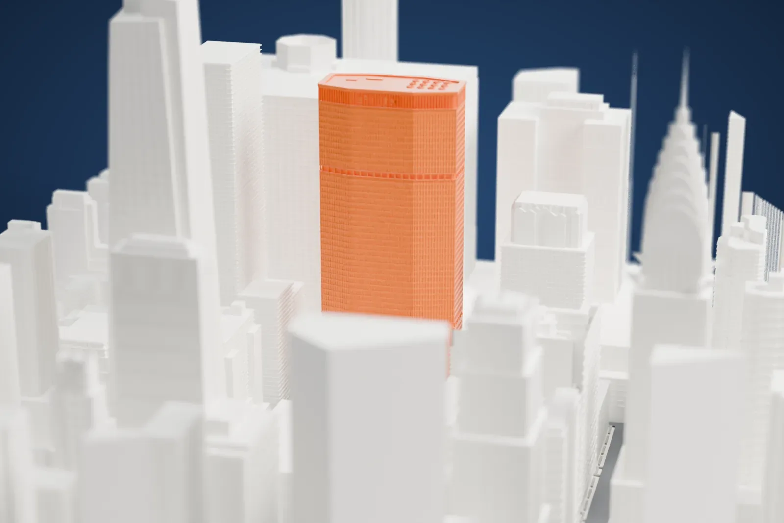 A white 3D print of the MetLife Building, a tall tower with an elongated octagonal outline and a fine window grid, packed in among other skyscrapers.