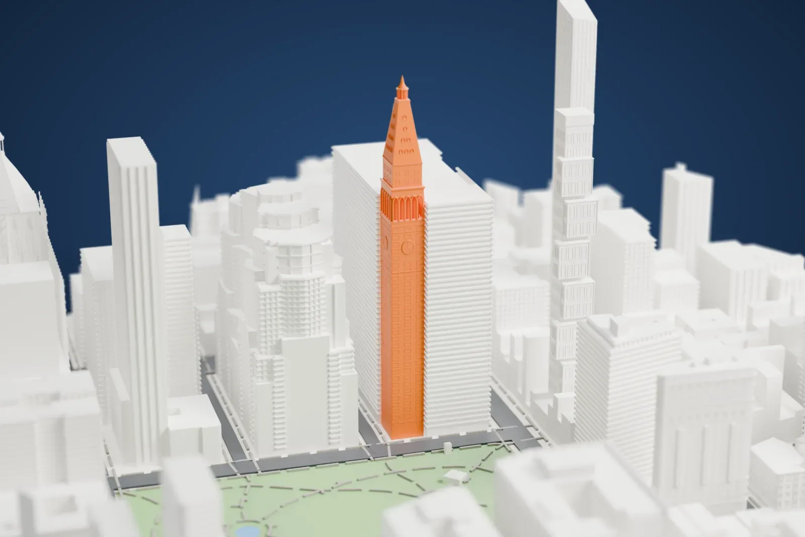 A white 3D print of the Metropolitan Life Insurance Company Tower, a slim clock tower with a pointed pyramid roof, surrounded by other tall buildings with a green park nearby.
