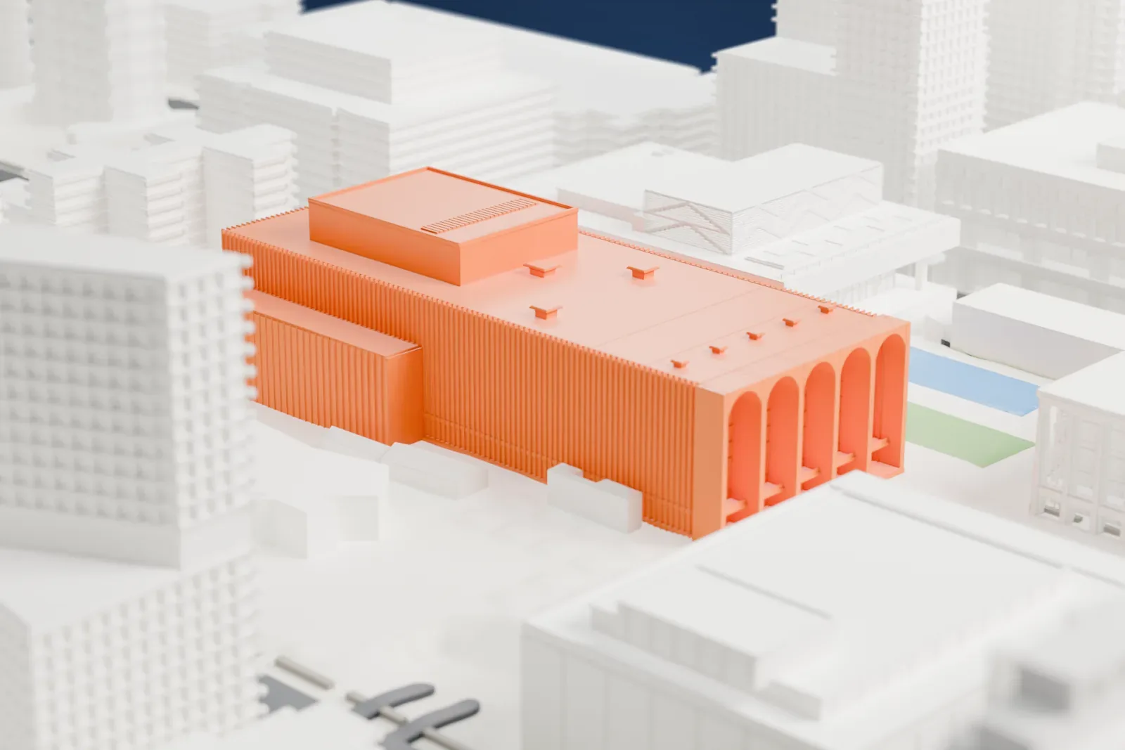 A white 3D print of the Metropolitan Opera House, a wide building with tall arched openings and a raised stage tower, beside a plaza with a small pool and surrounded by taller buildings.