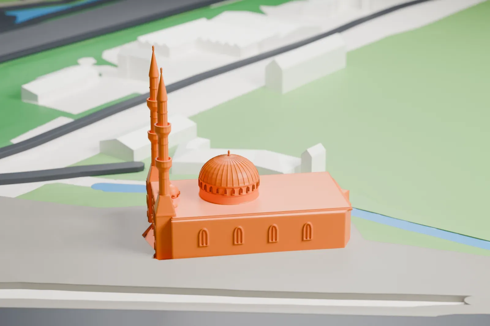 A white 3D print of the Mevlana Mosque among the surrounding streets and buildings.