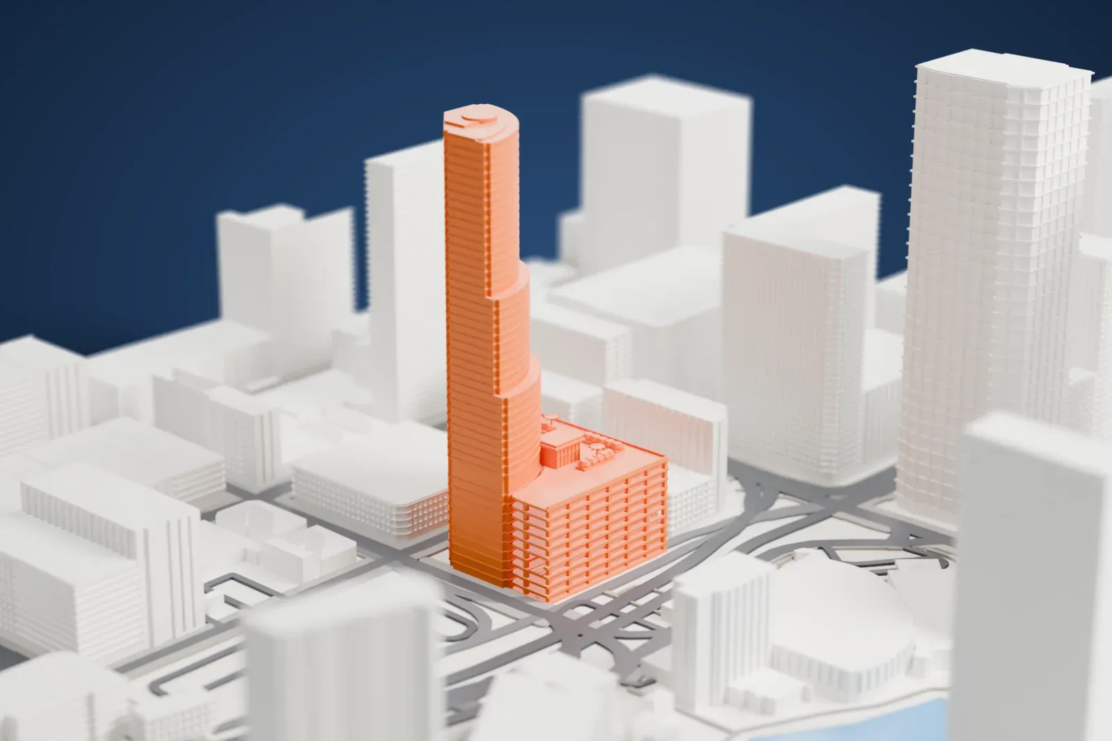 A white 3D print of the Miami Tower, its three curved glass tiers rising above a parking garage, among surrounding buildings.