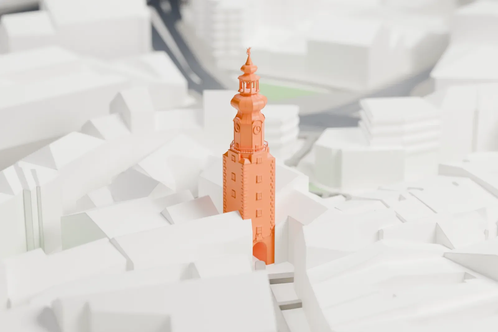 A white 3D print of Michael's Gate, a tall square tower with an open passage, clock stage and two bulbous crowns, among the surrounding streets and buildings of Bratislava.